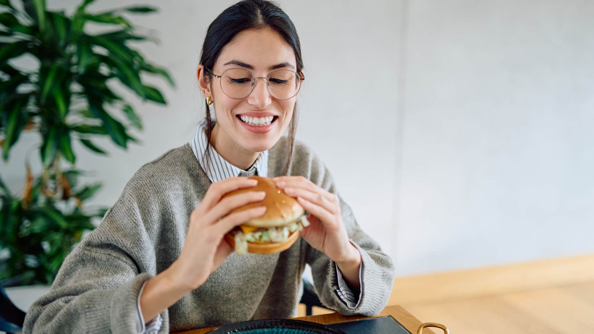 woman eating fast food meal at home