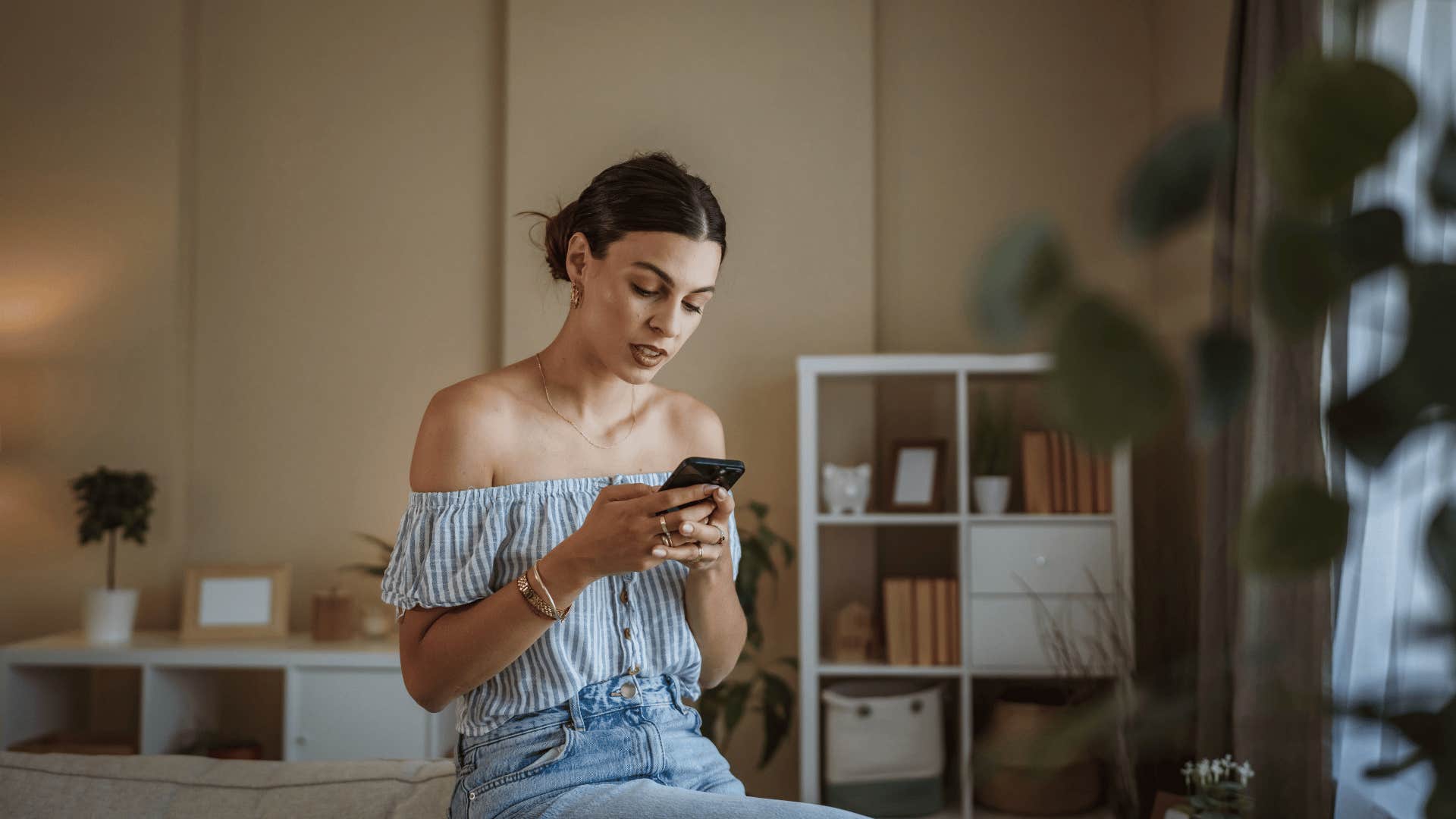 woman who is thinking of someone and they text that seems like a coincidence but isn't