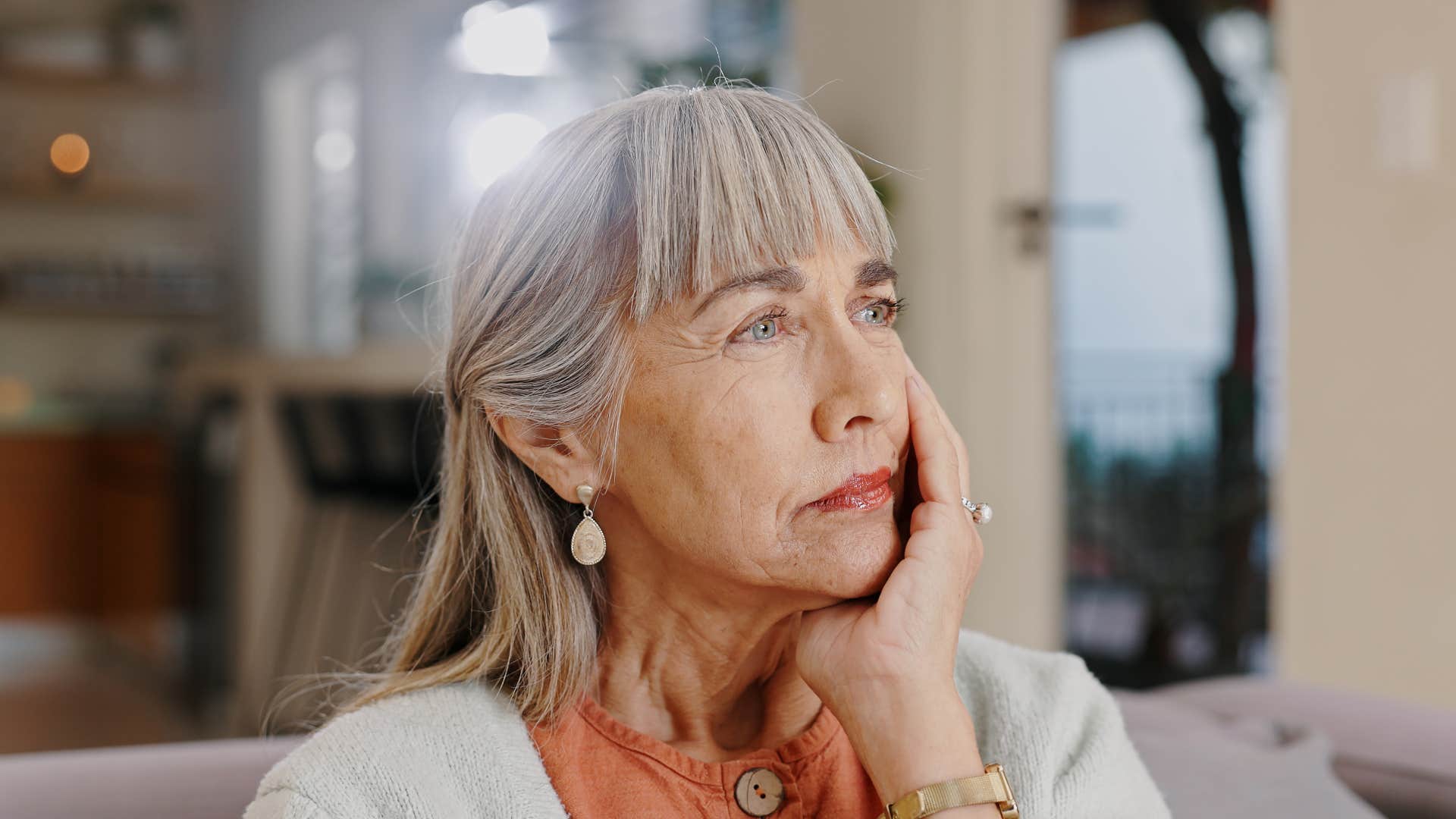 woman sitting on couch thinking 