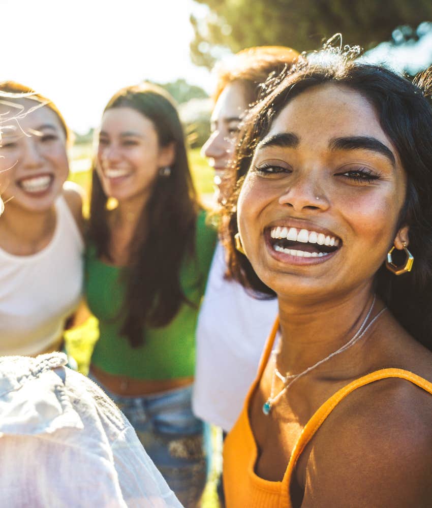 Happy person with group of friends showing love is learned