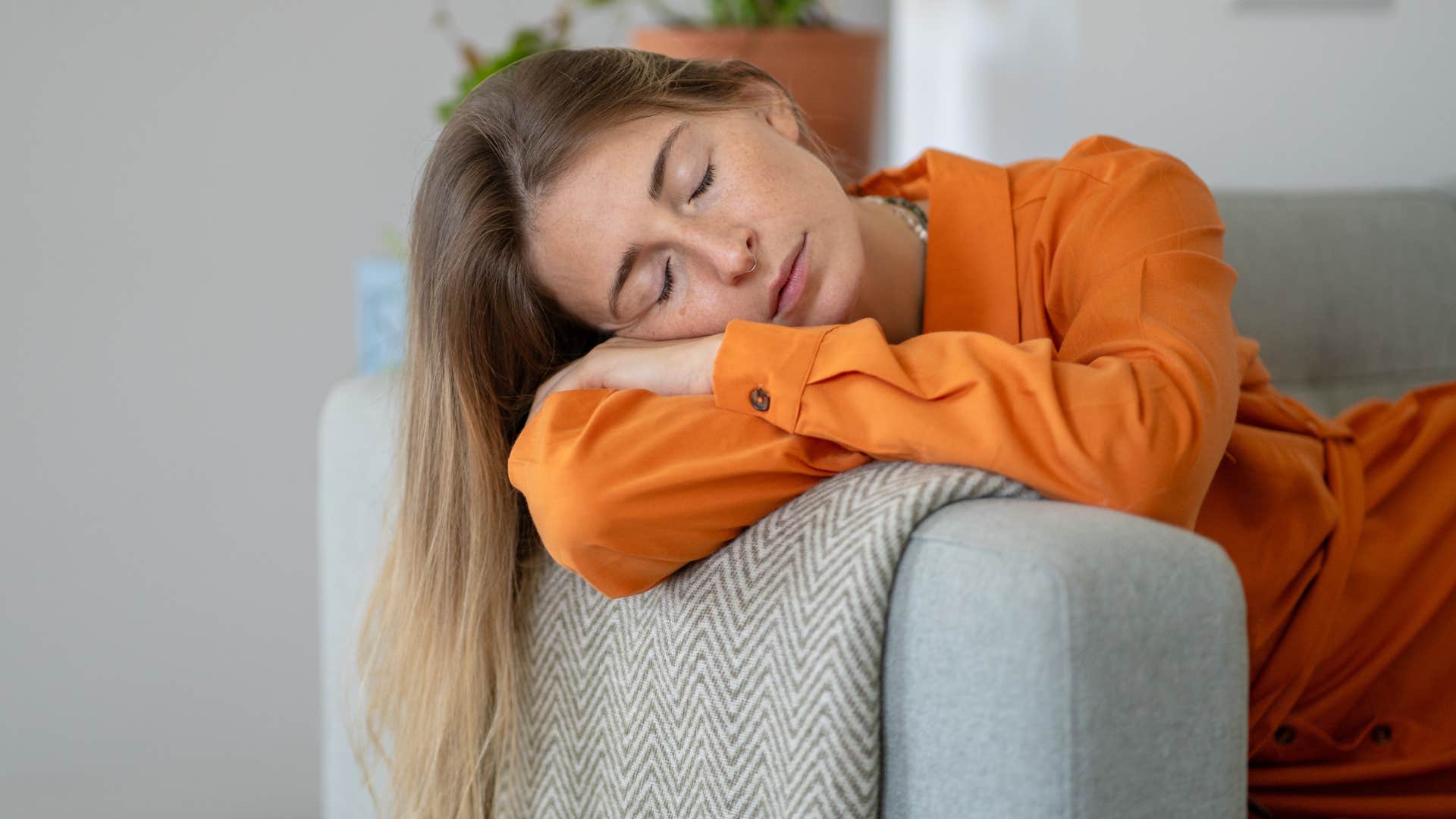 woman in orange tired as the energy taker has drained her