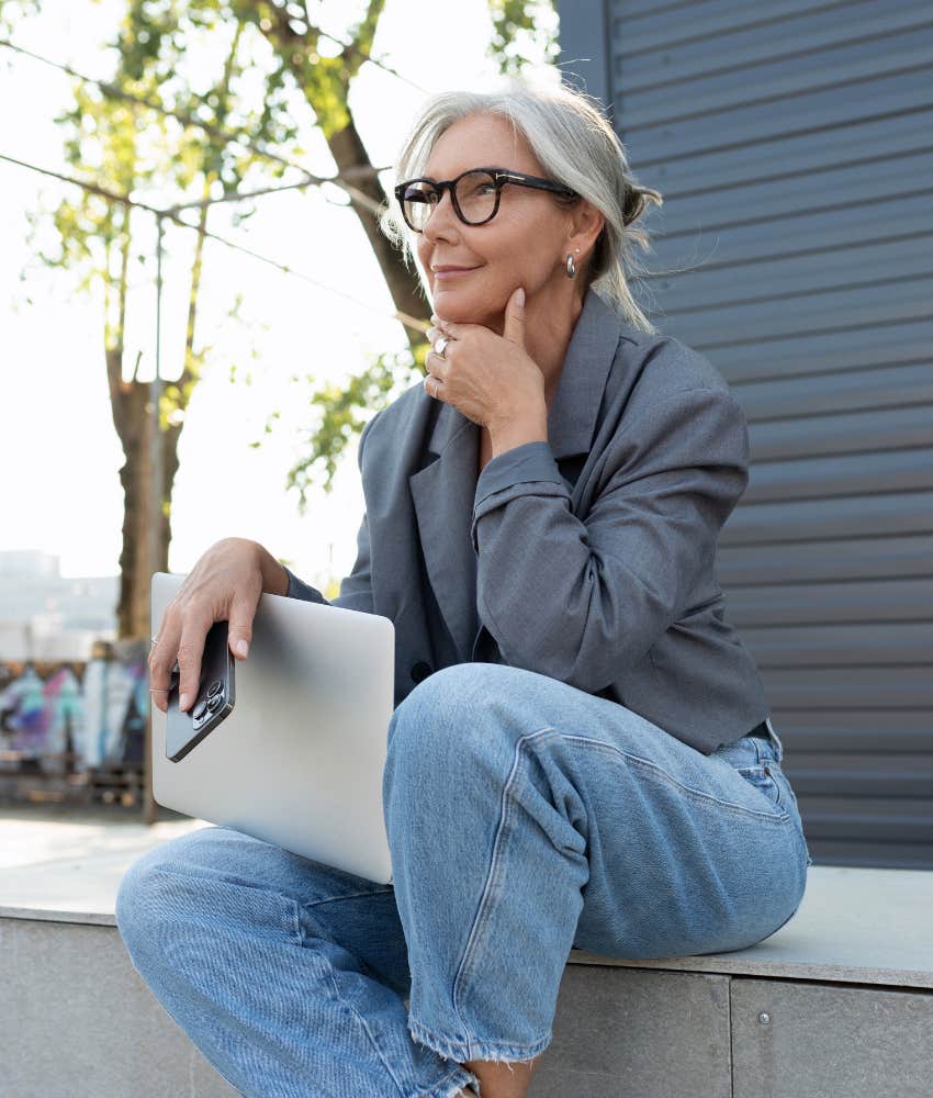 introspetive woman with laptop and phone showing desire to follow virtual romance