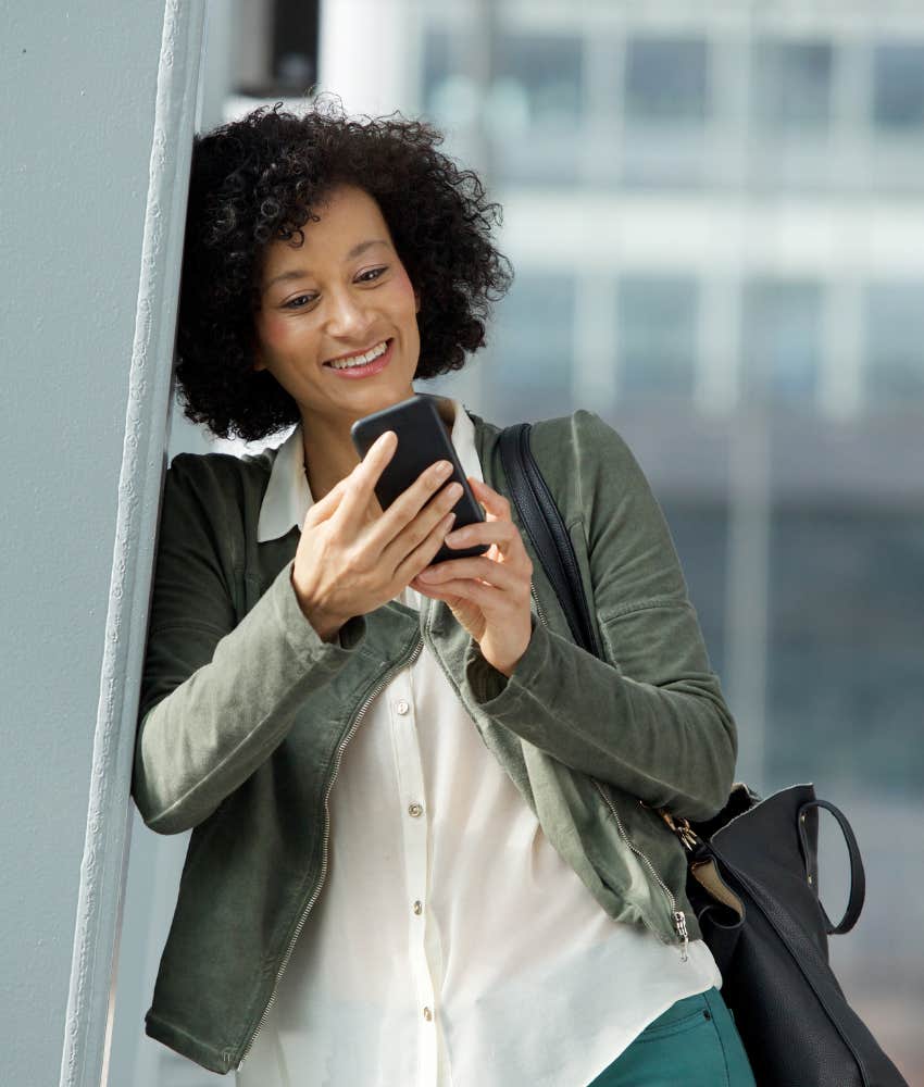 Happy woman reads text message showing virtual romance
