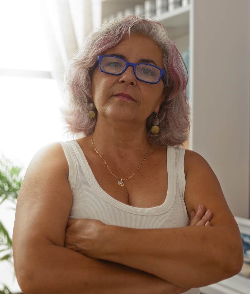 Confident person crosses arms defensively showing past hurt