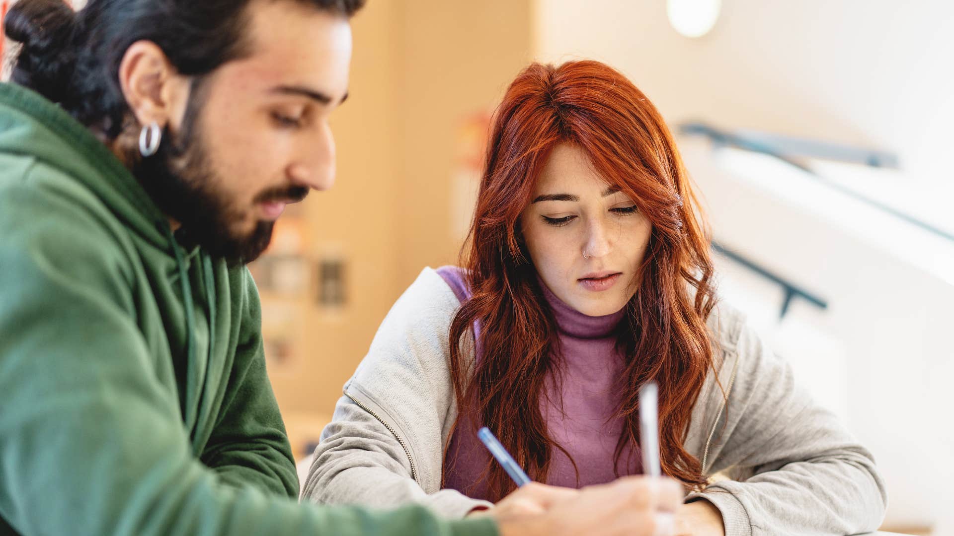 Woman studying with a man who lets her know it's easy to take advantage of him