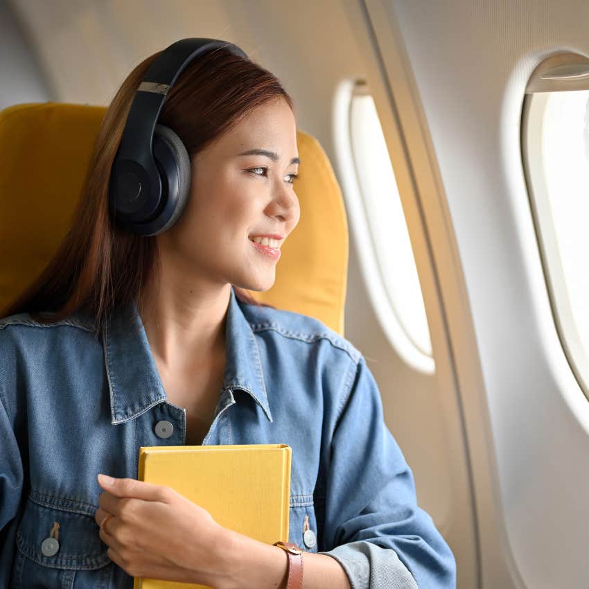 woman following united's new rules and wearing headphones on flight