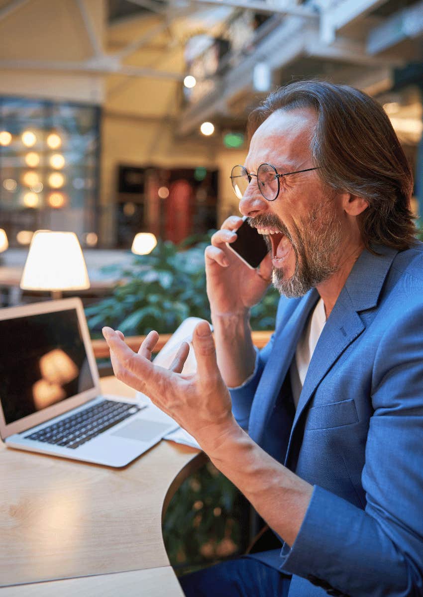upset middle age man yelling into his phone