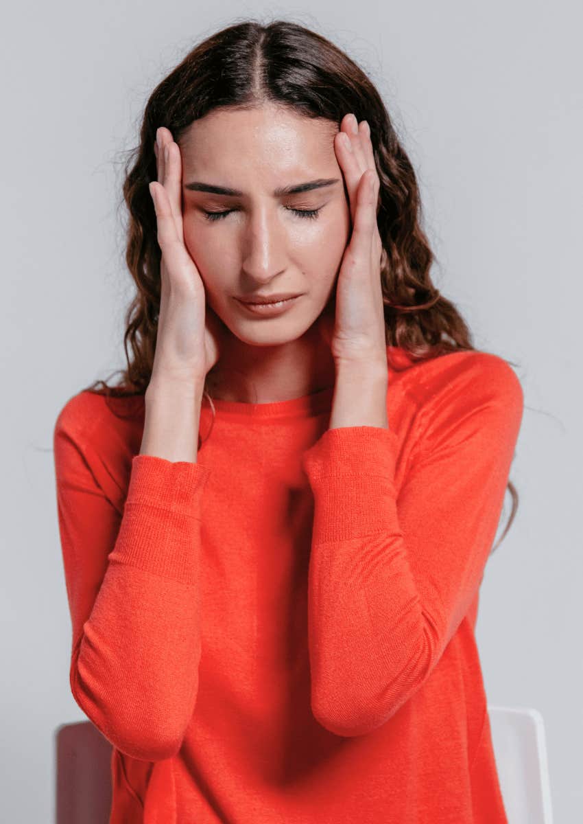 upset woman closing her eyes in despair