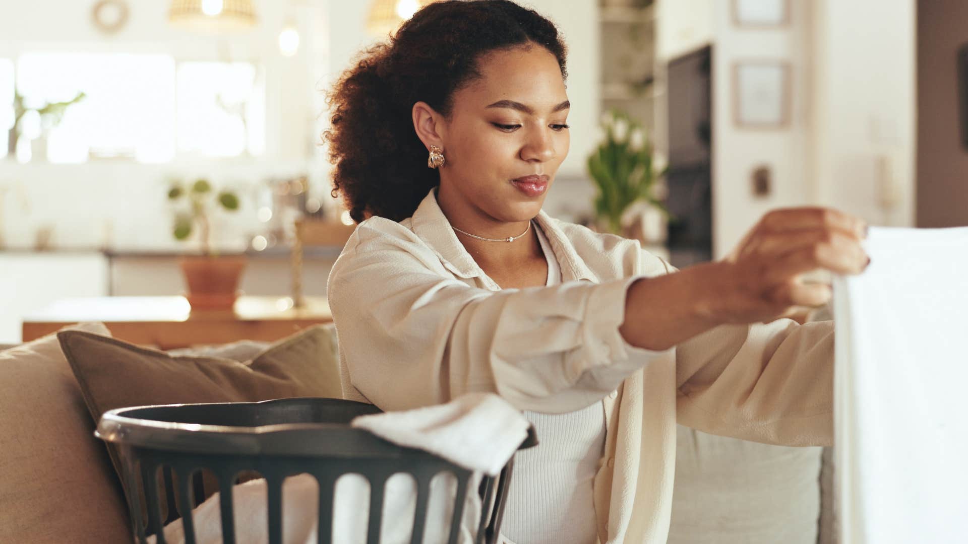 calm person folds clothes showing they have their life together