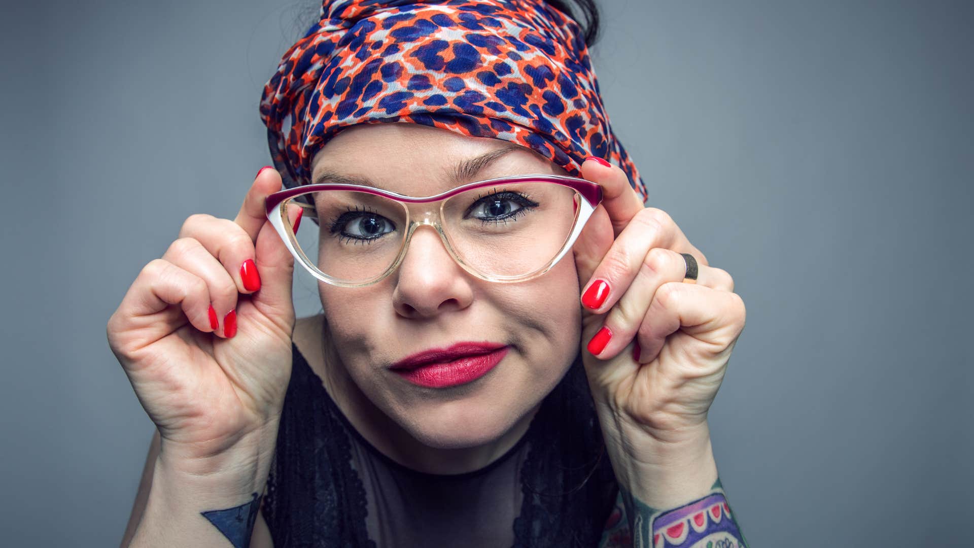 curious person covers hair with scarf showing they have life together