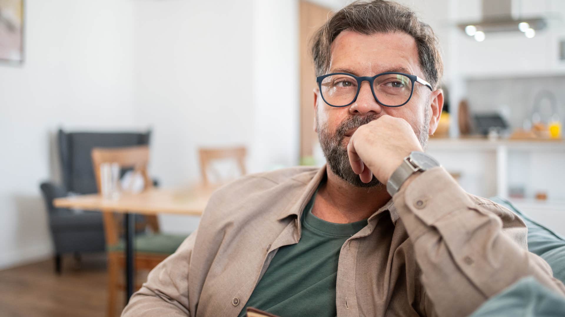 man who seems more comfortable alone sitting on his couch
