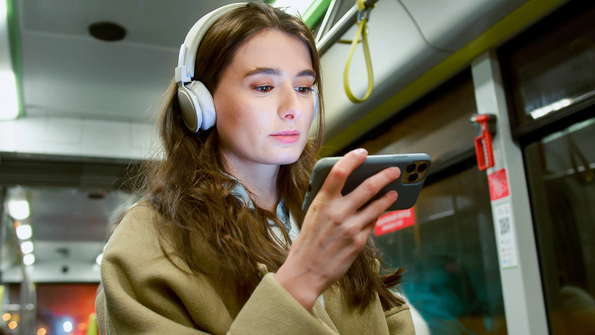 introverted woman wearing headphones while running errands in public