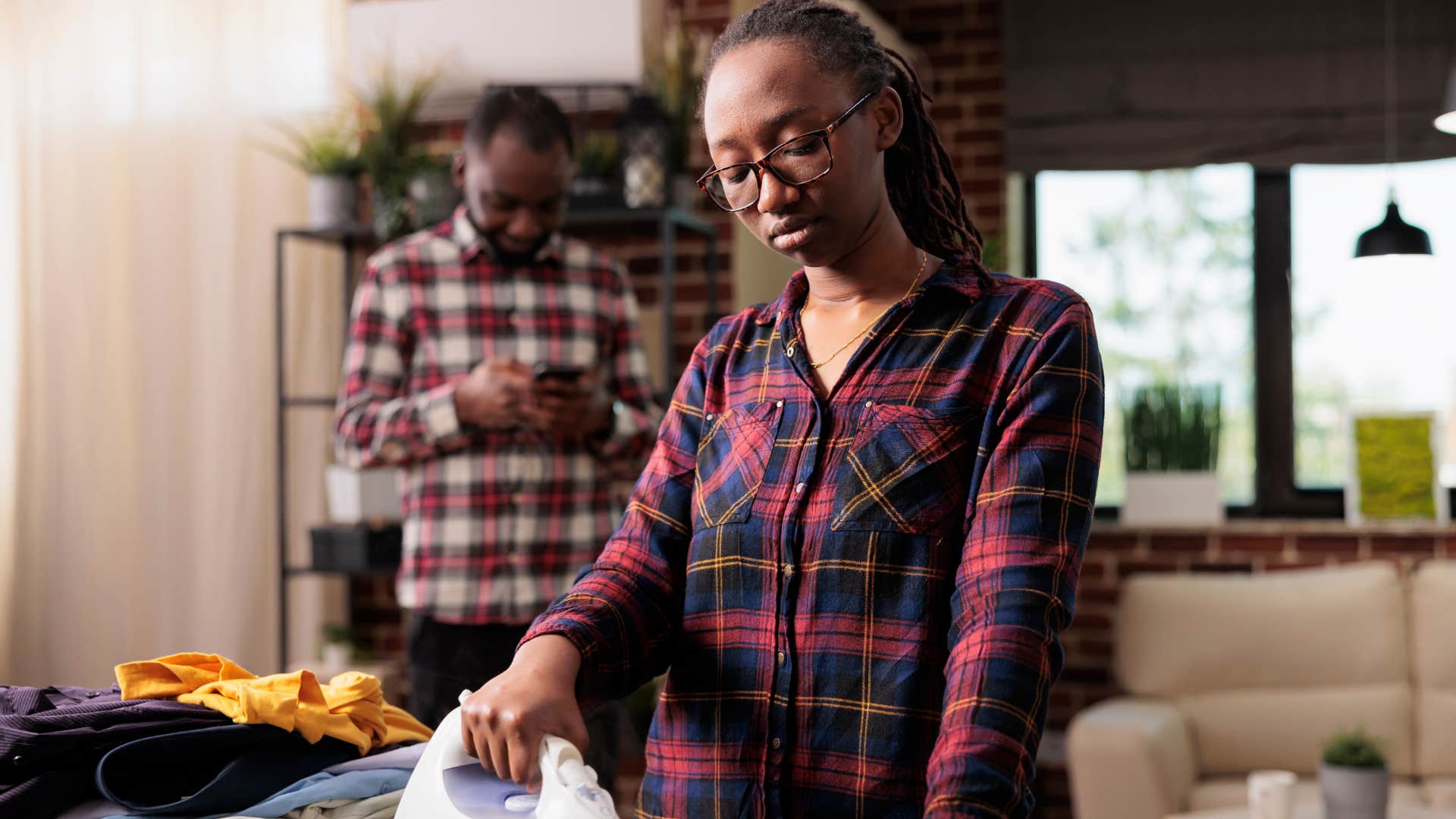 lonely and misunderstood woman ironing clothes with no space for solitude