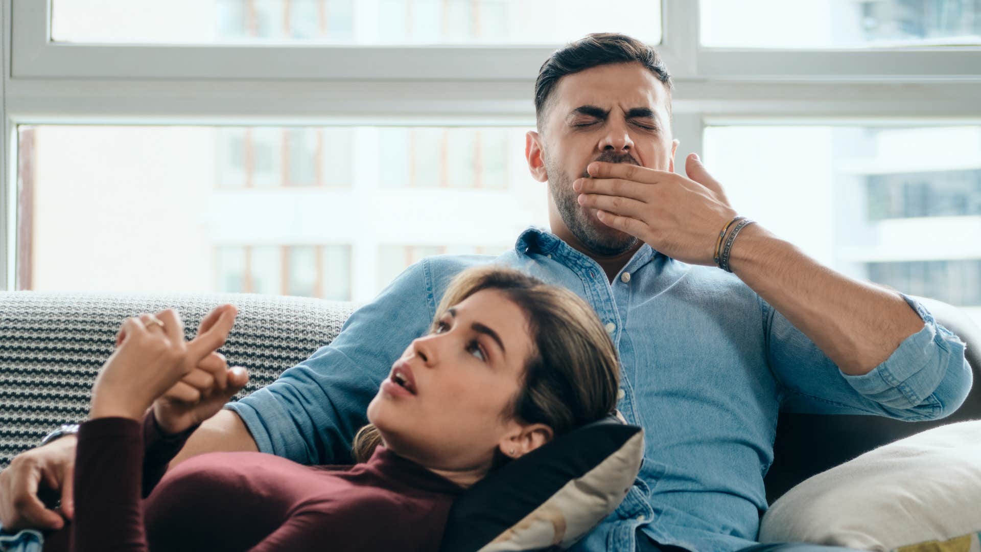 man yawning while wife talks about her interests