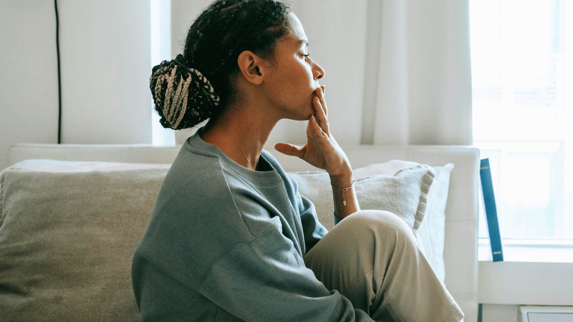 woman alone in bedroom thinking about relationship with step children