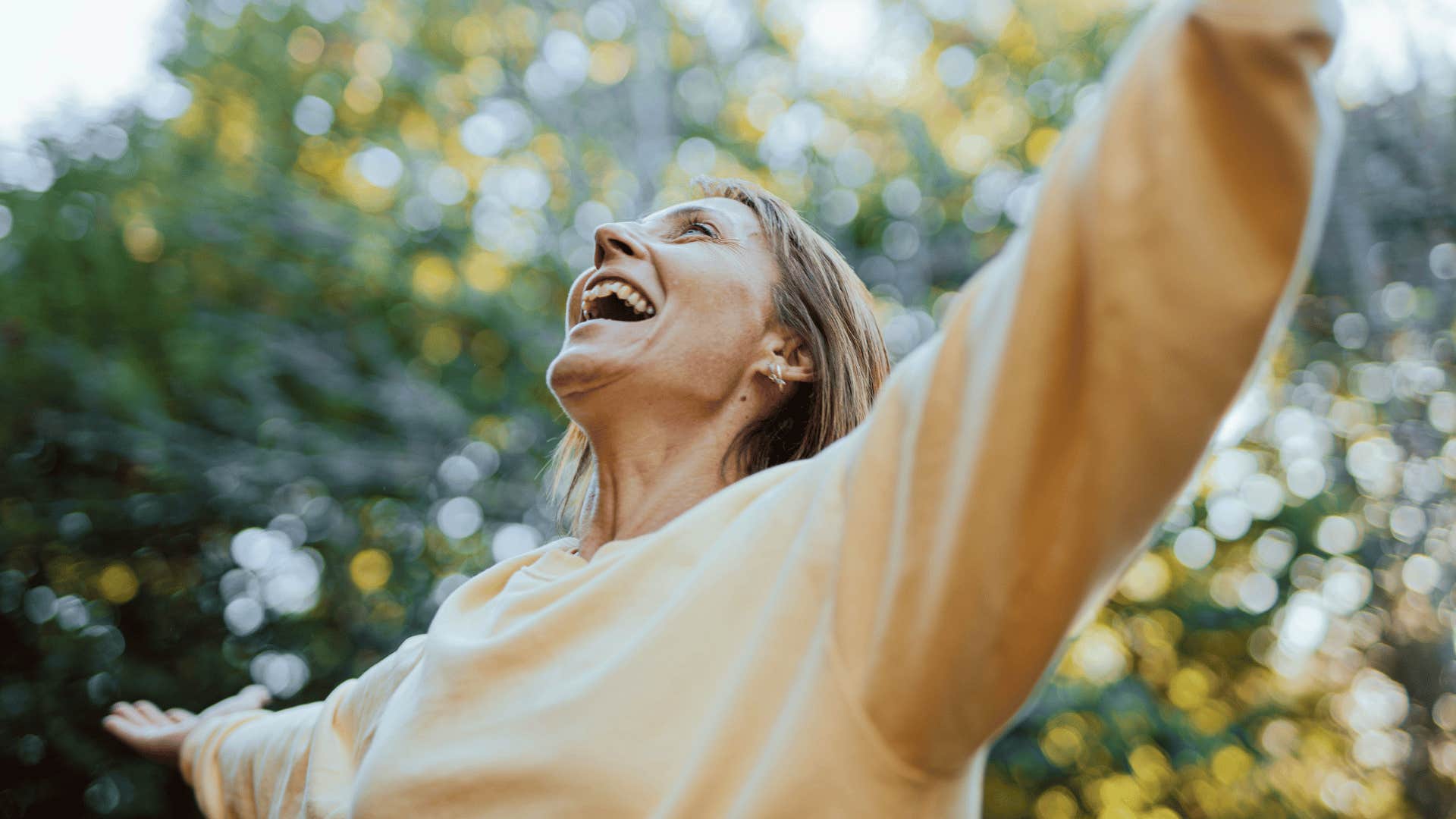 woman with her arms raised celebrating progress to help when things feel like too much effort