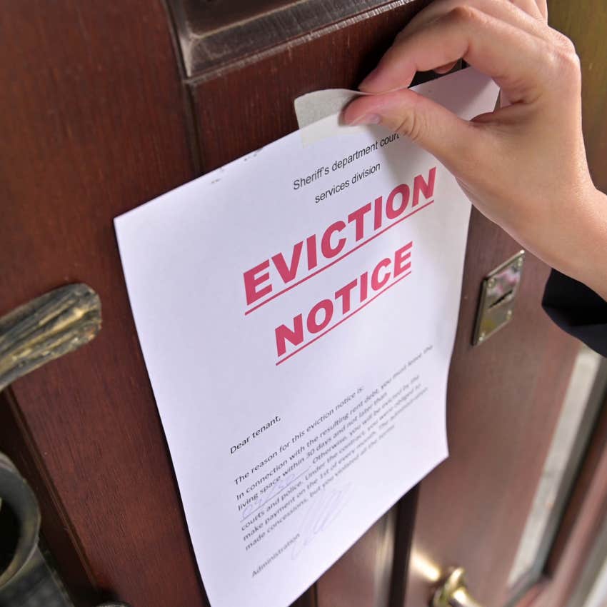 woman putting eviction notice on her stepmother's front door
