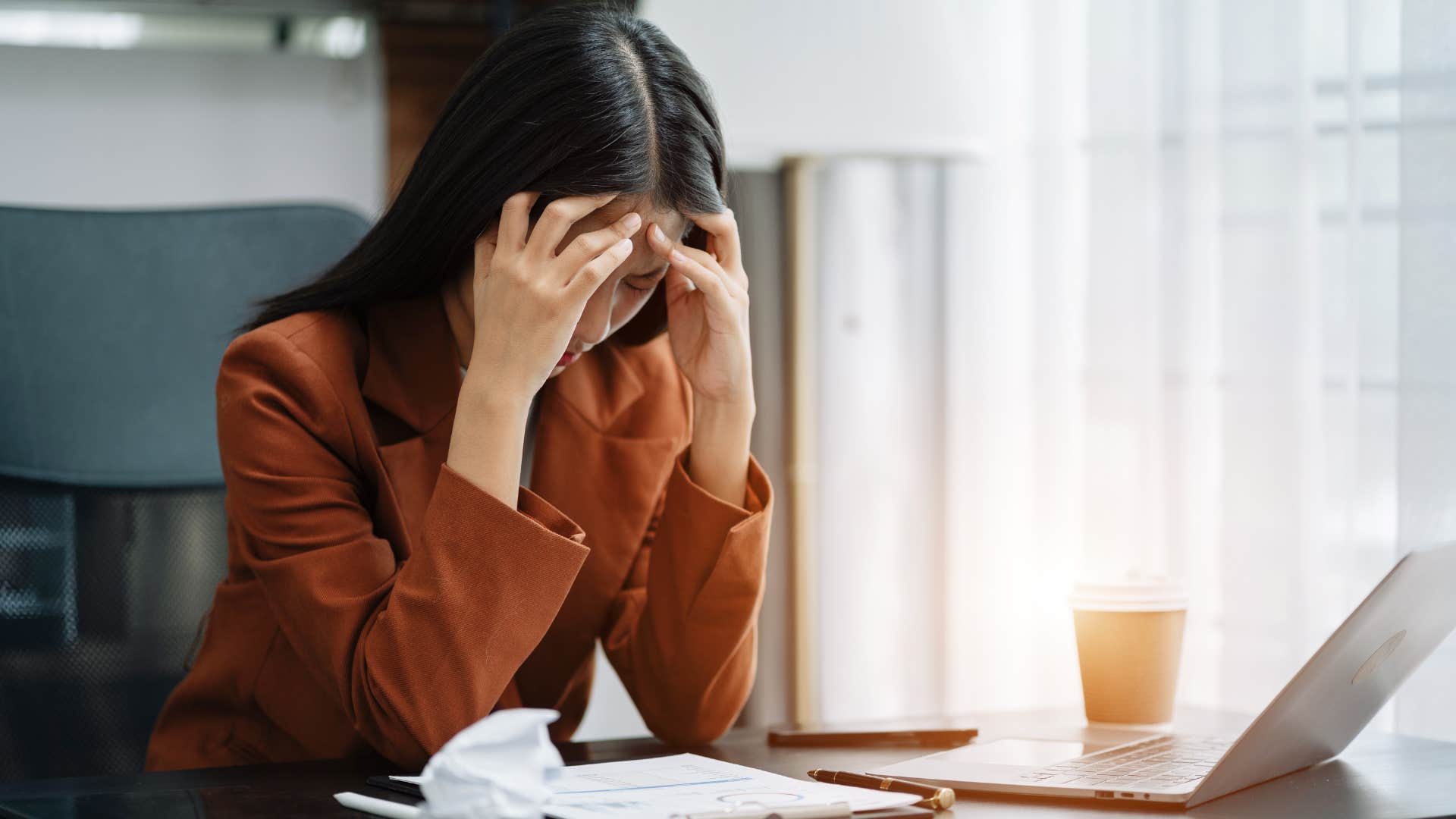 woman in orange shirt gets overwhelmed easily