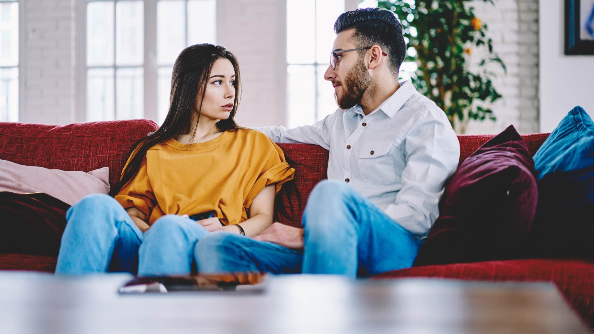 woman in yellow listening to man talk as her empathy is extremely high