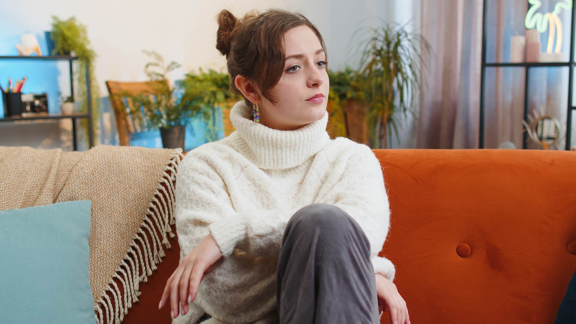 woman who watches videos on her phone before bed because she overthinks