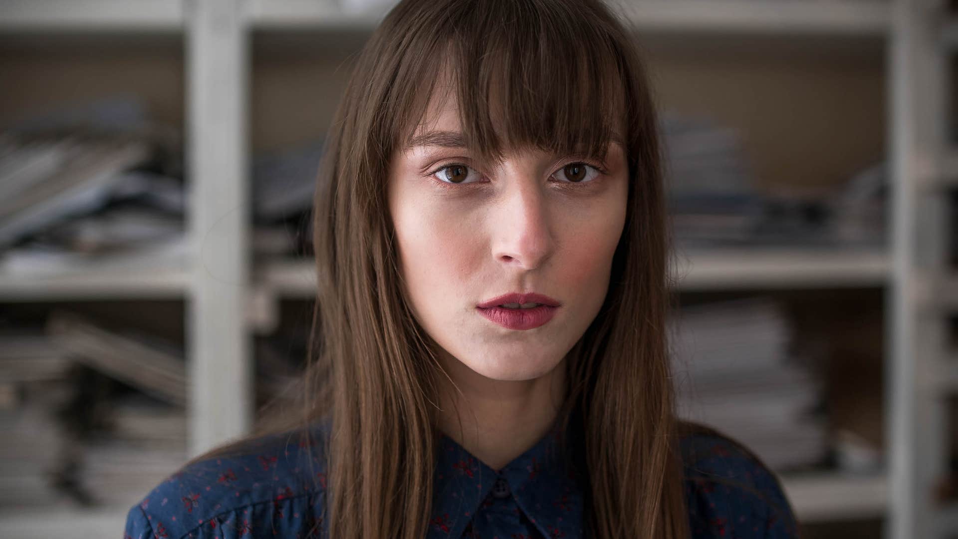 woman suppressing her feelings looking exhausted