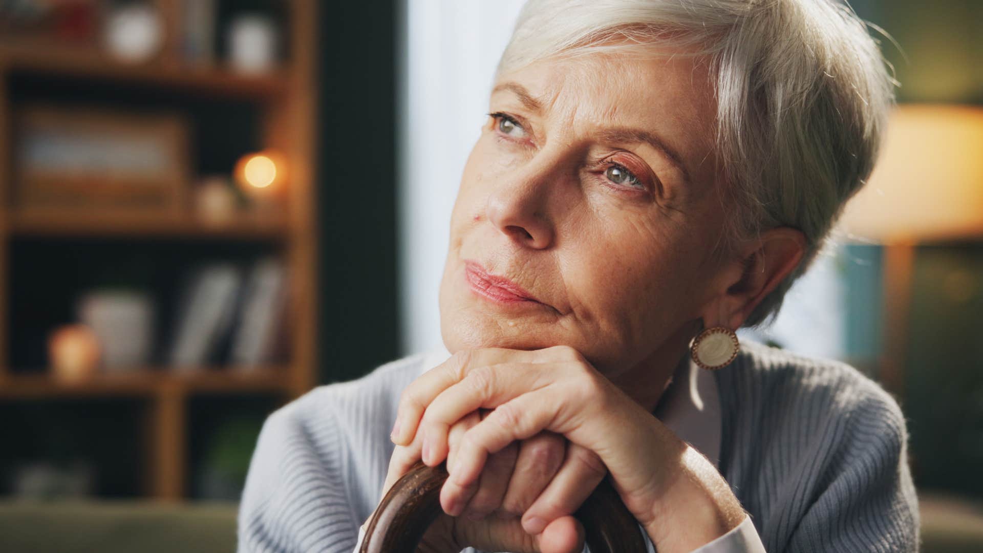 Woman who's guarded with trust thinking at home.