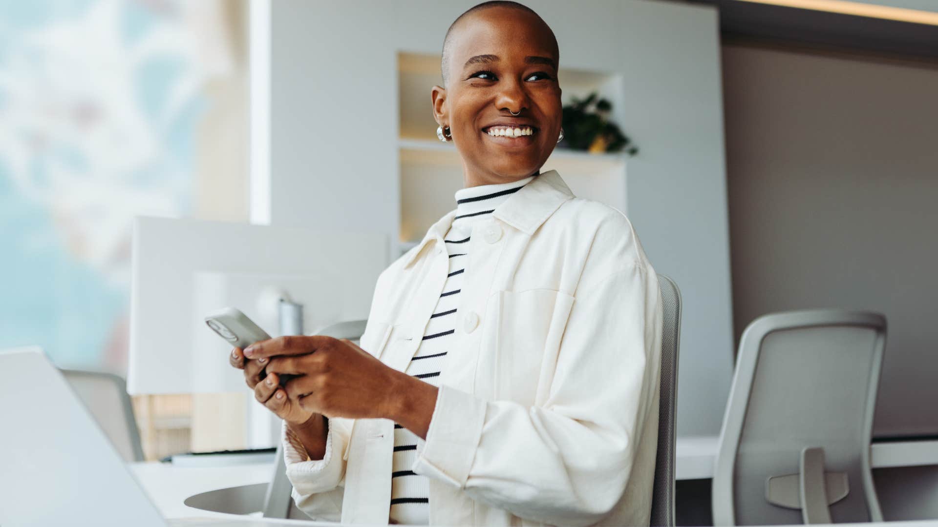 Motivated and disciplined woman smiling at work.