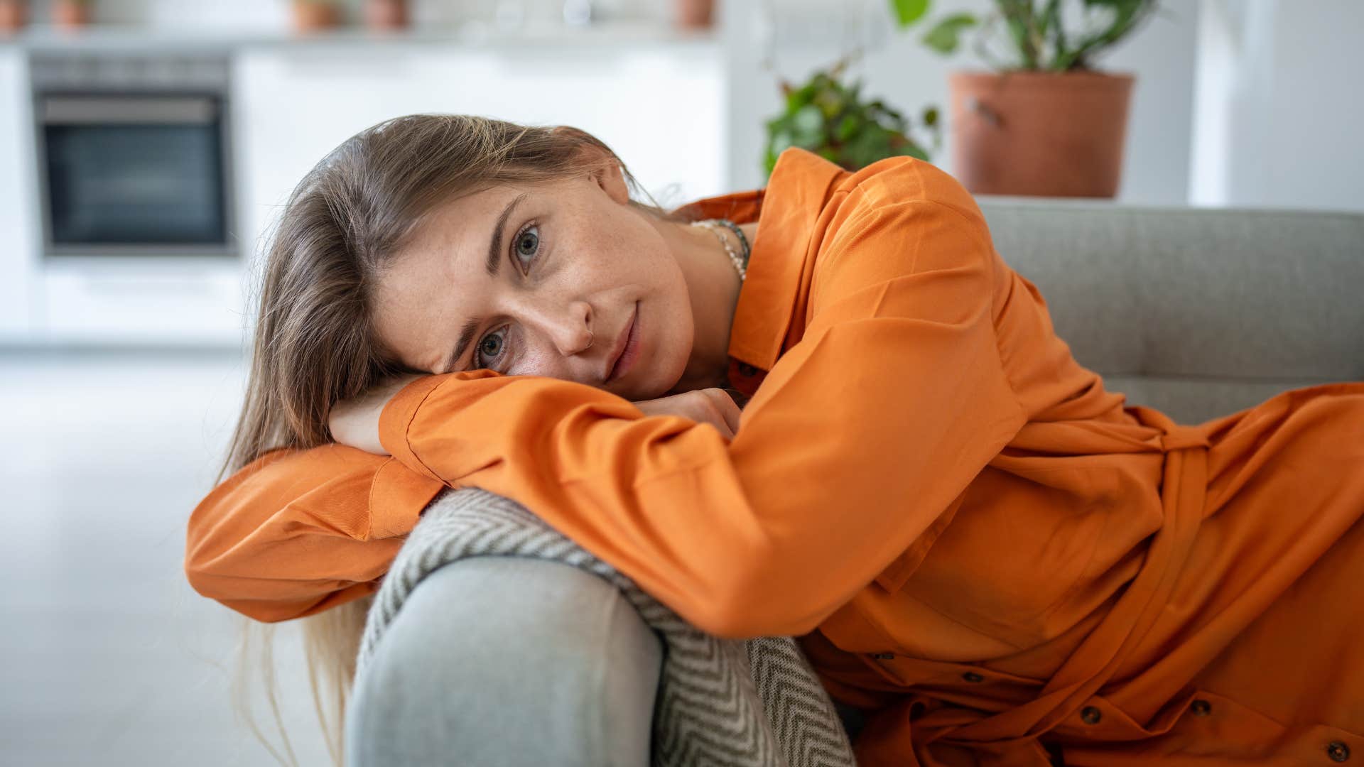 Woman who's protective of their energy sitting at home.