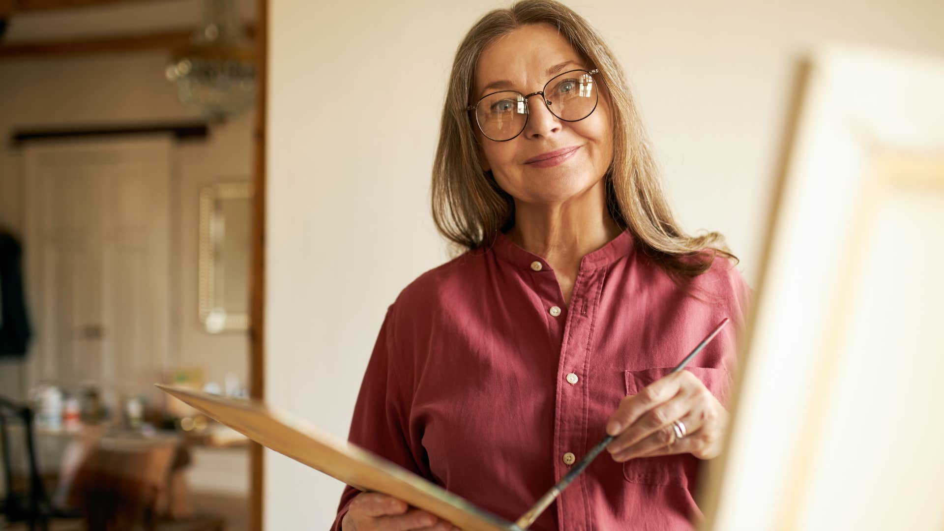 Woman with a rich sense of imagination painting at home.