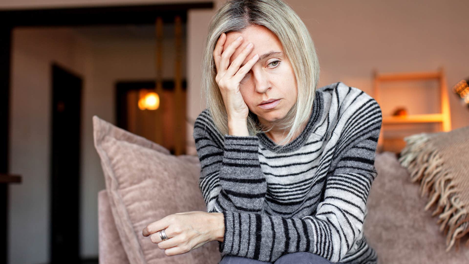 woman who carries a lot of emotional stress sitting at home