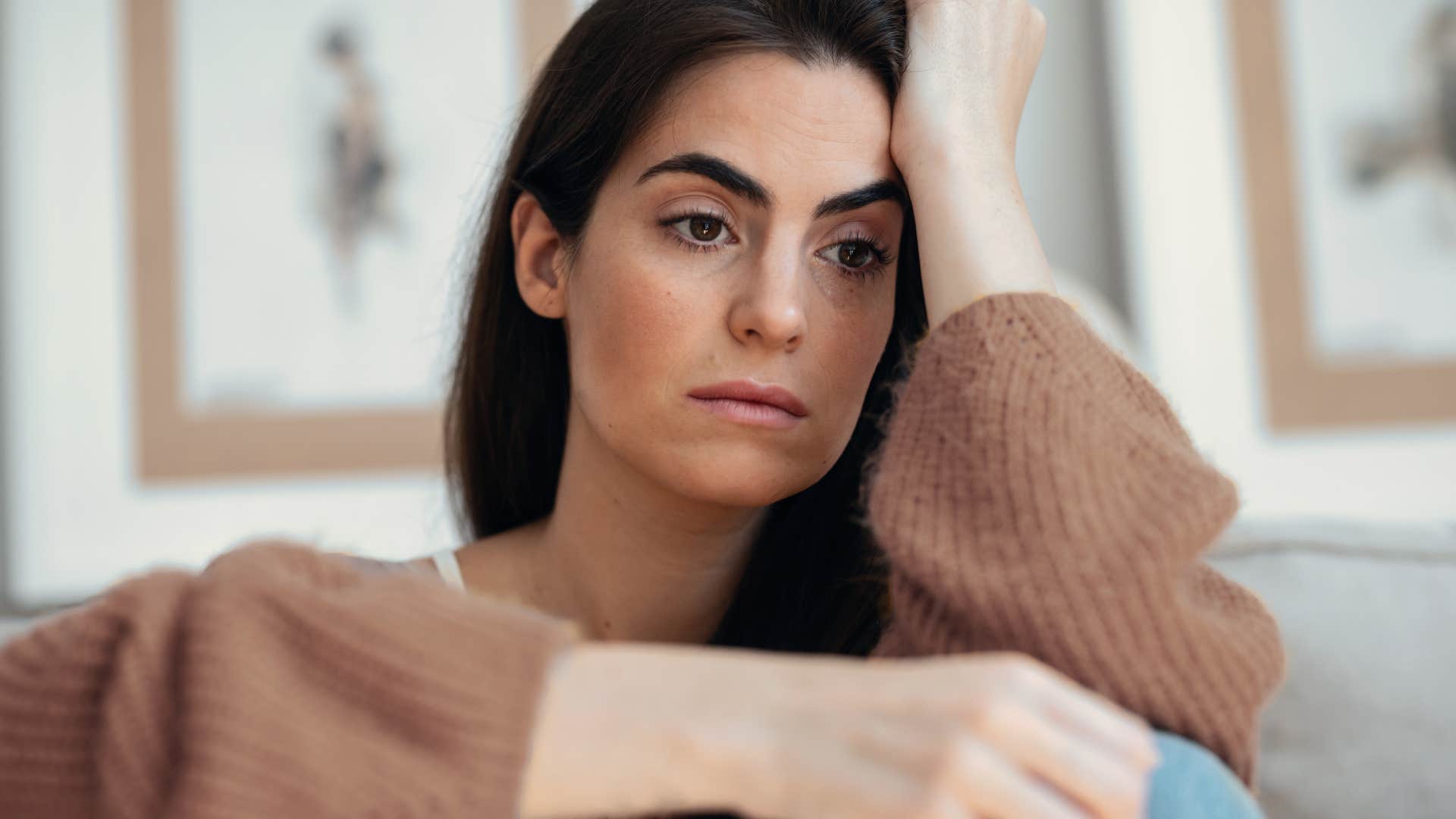 woman with a lot on her plate looking stressed at home