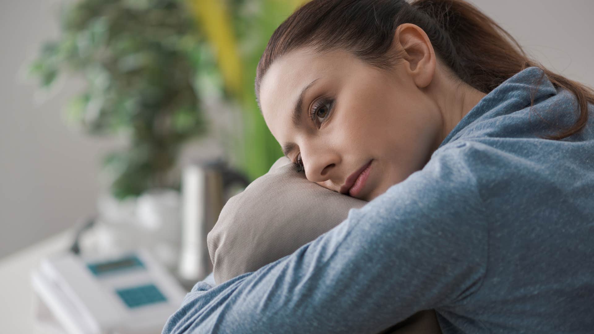 highly sensitive woman sitting alone home enjoying solitude
