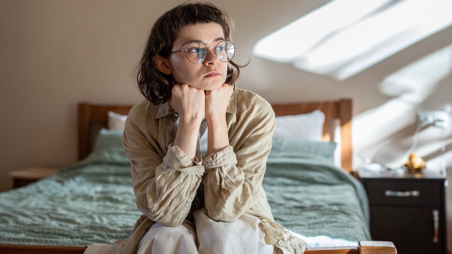 introspective woman sitting alone at home