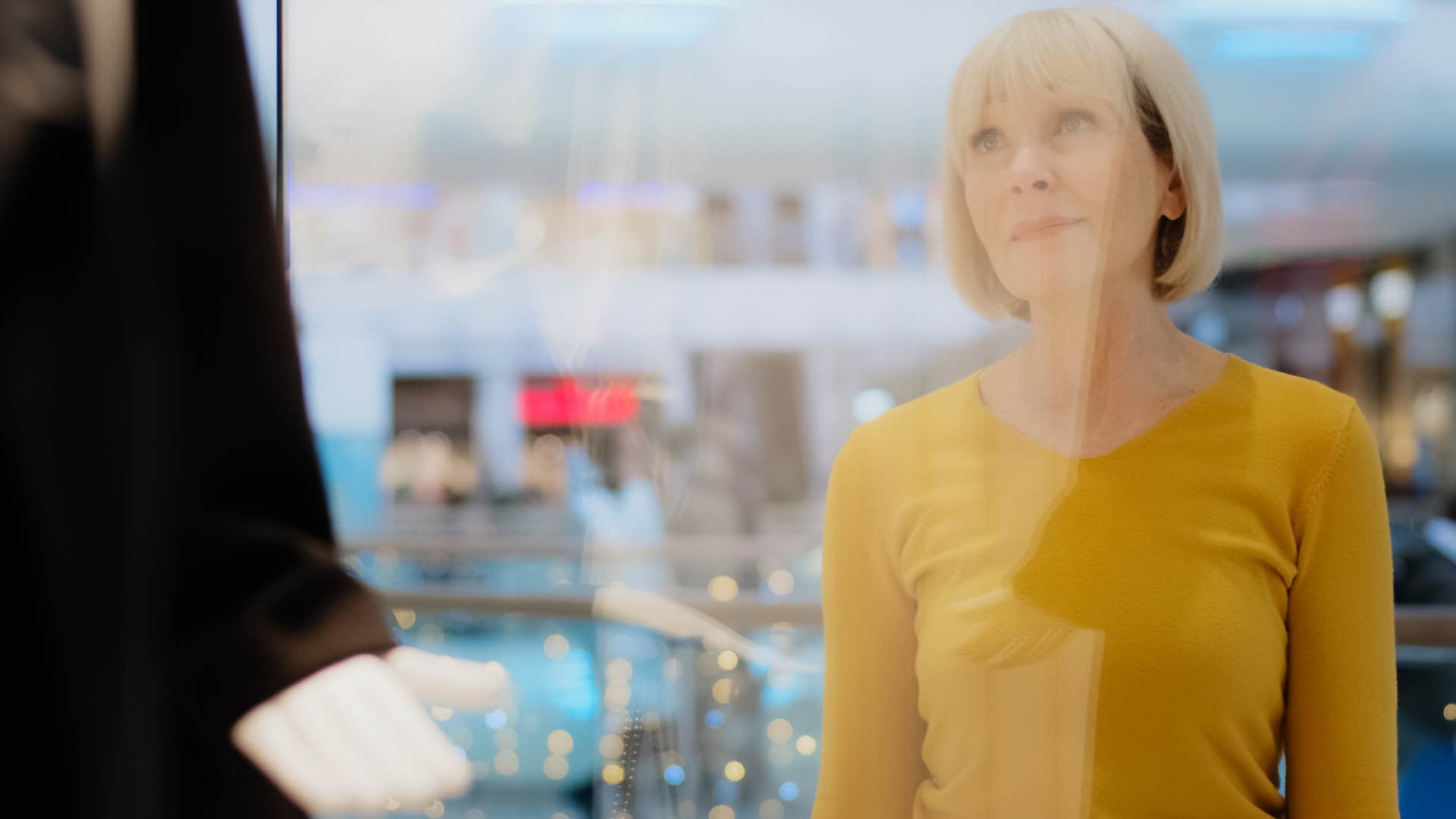 woman who's less persuaded by traditional marketing looking in a shop window