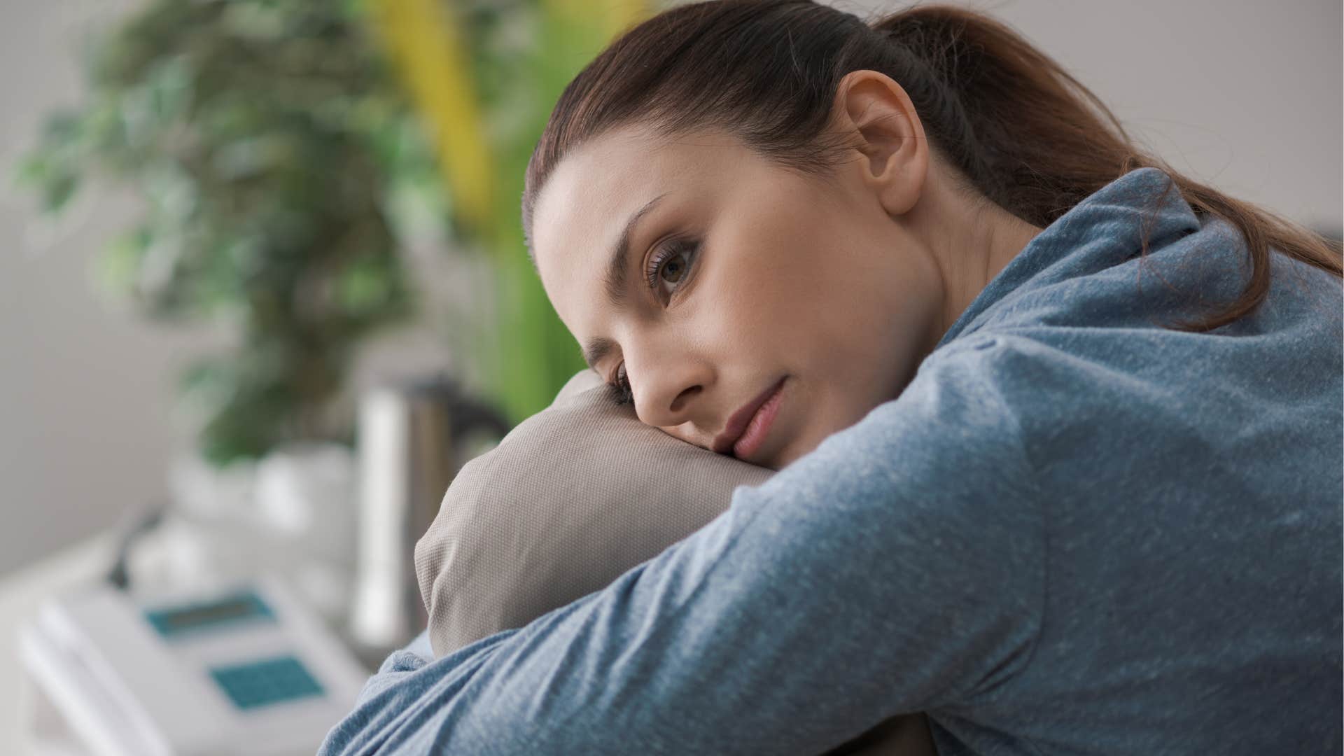 Highly sensitive woman sitting at home.