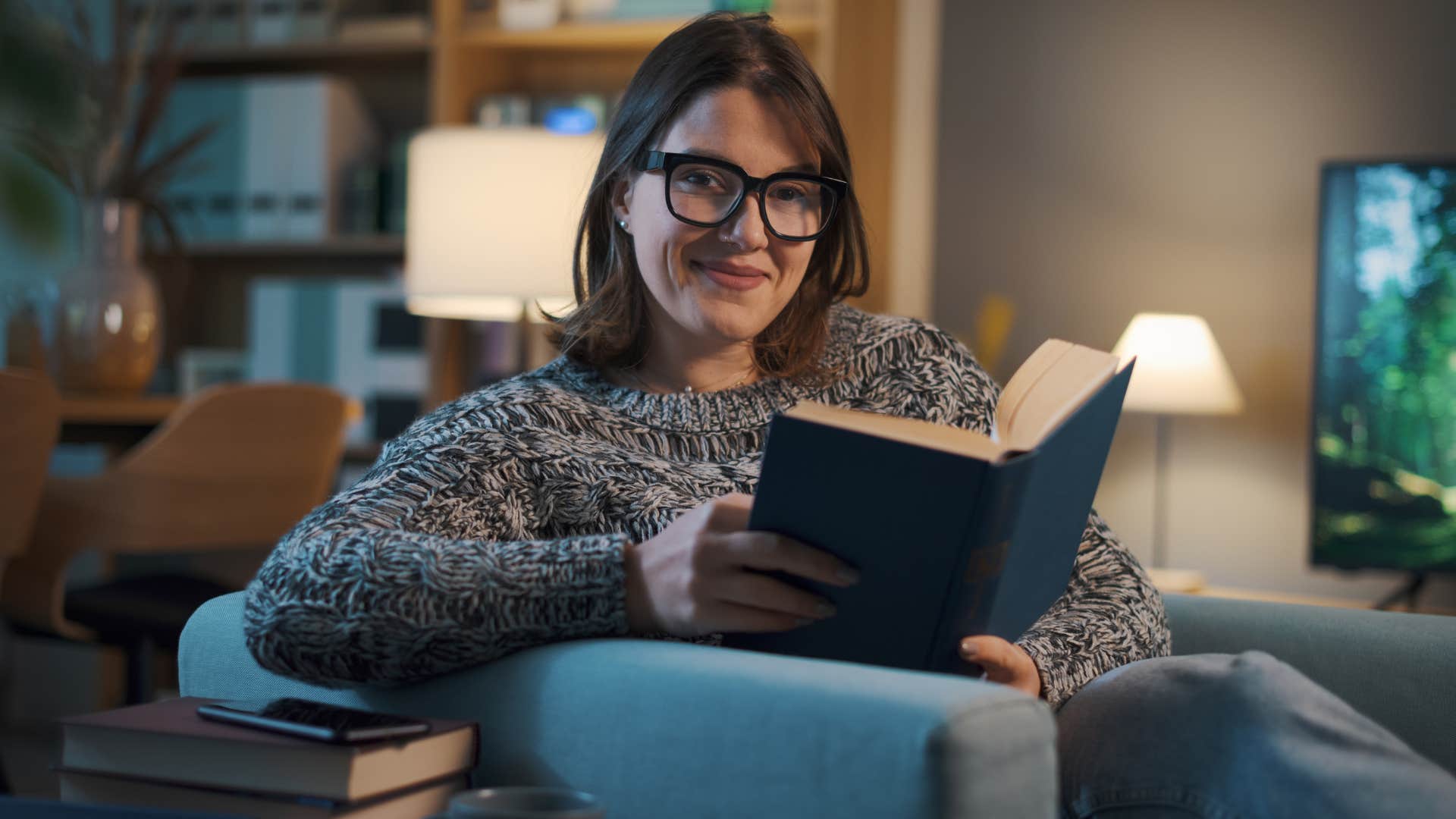 Woman who's secure enough to be misunderstood reading at home.
