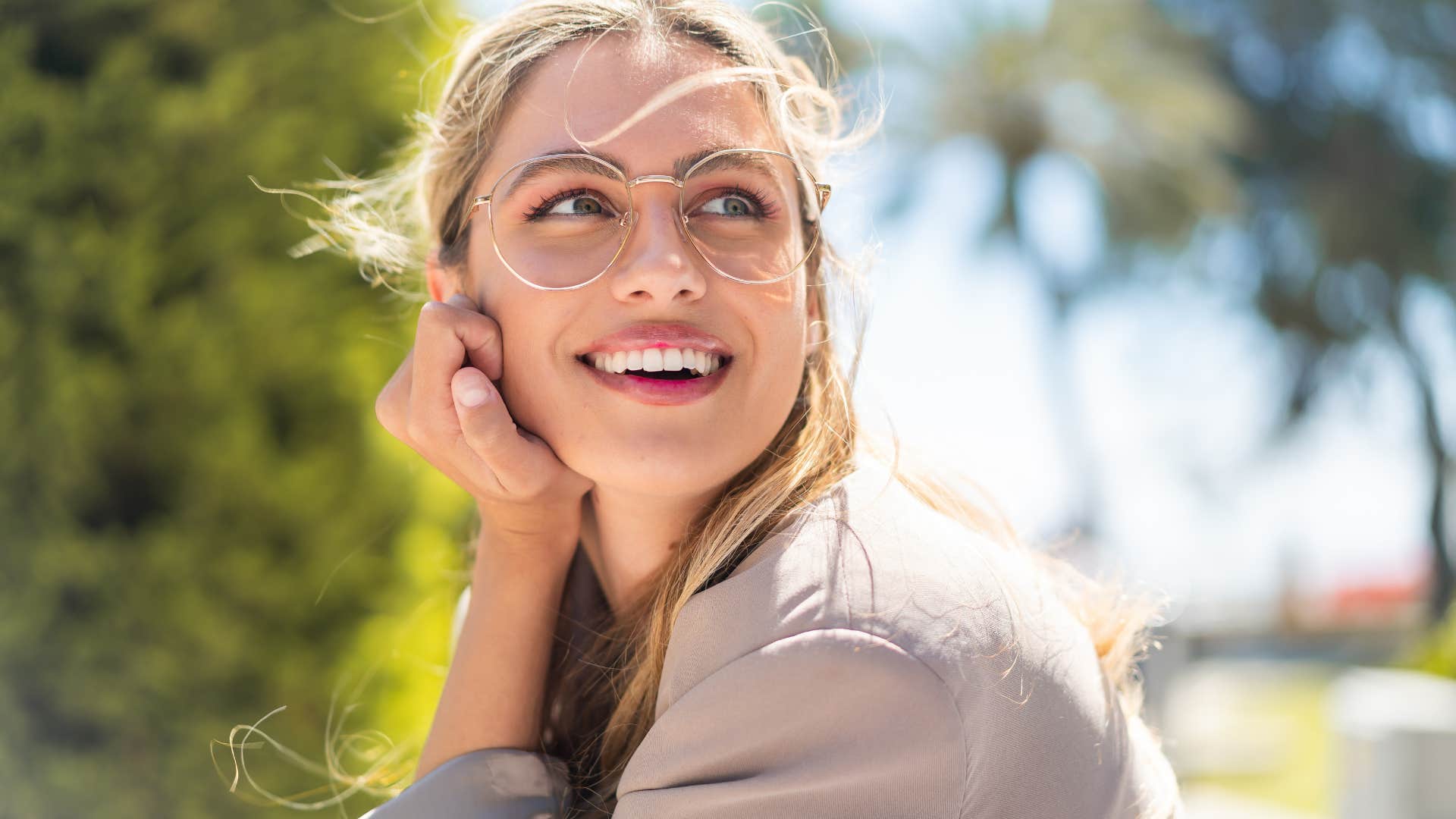 deeply sentimental woman smiling outside
