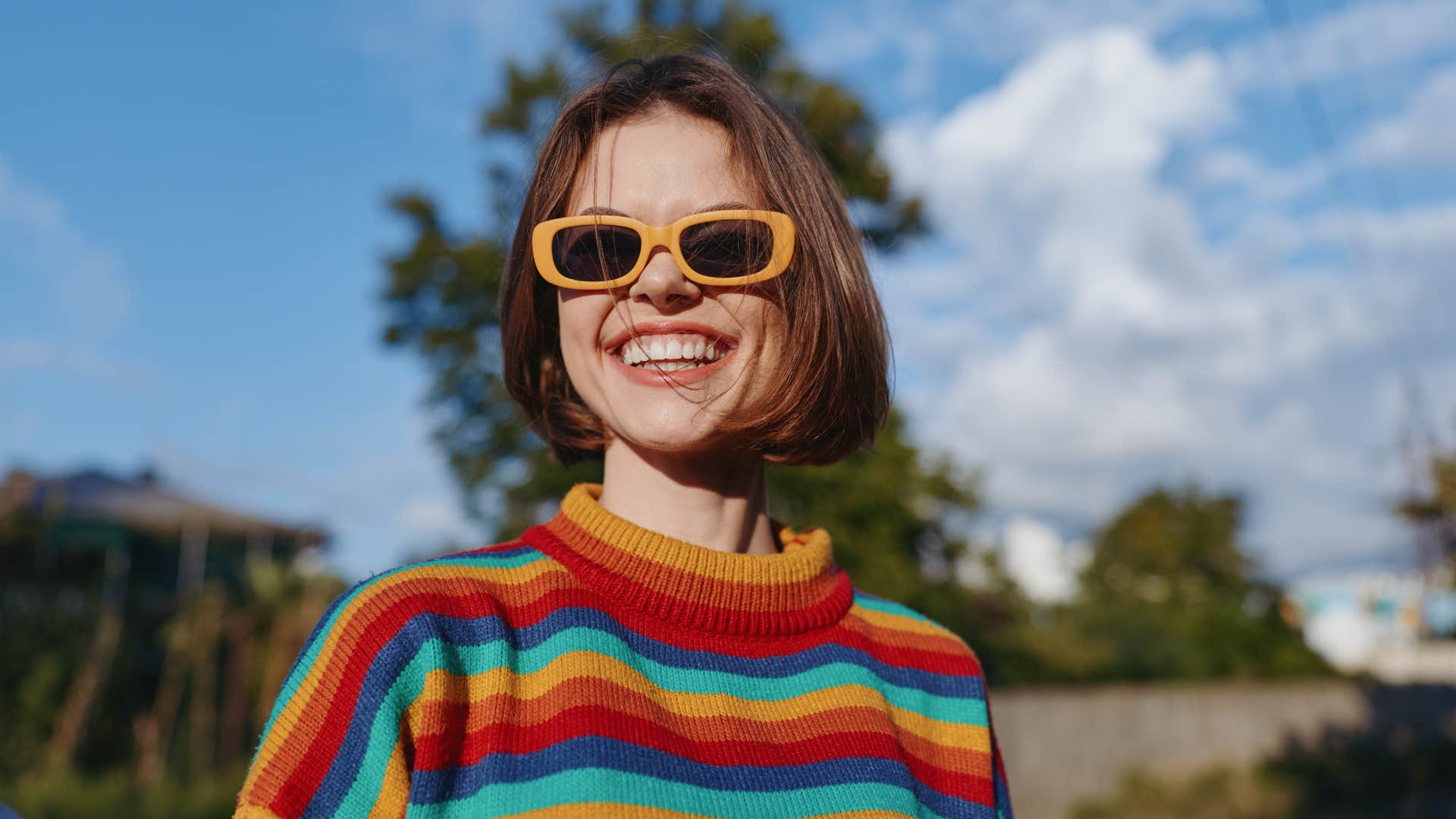 woman smiling outside romanticizing ordinary moments