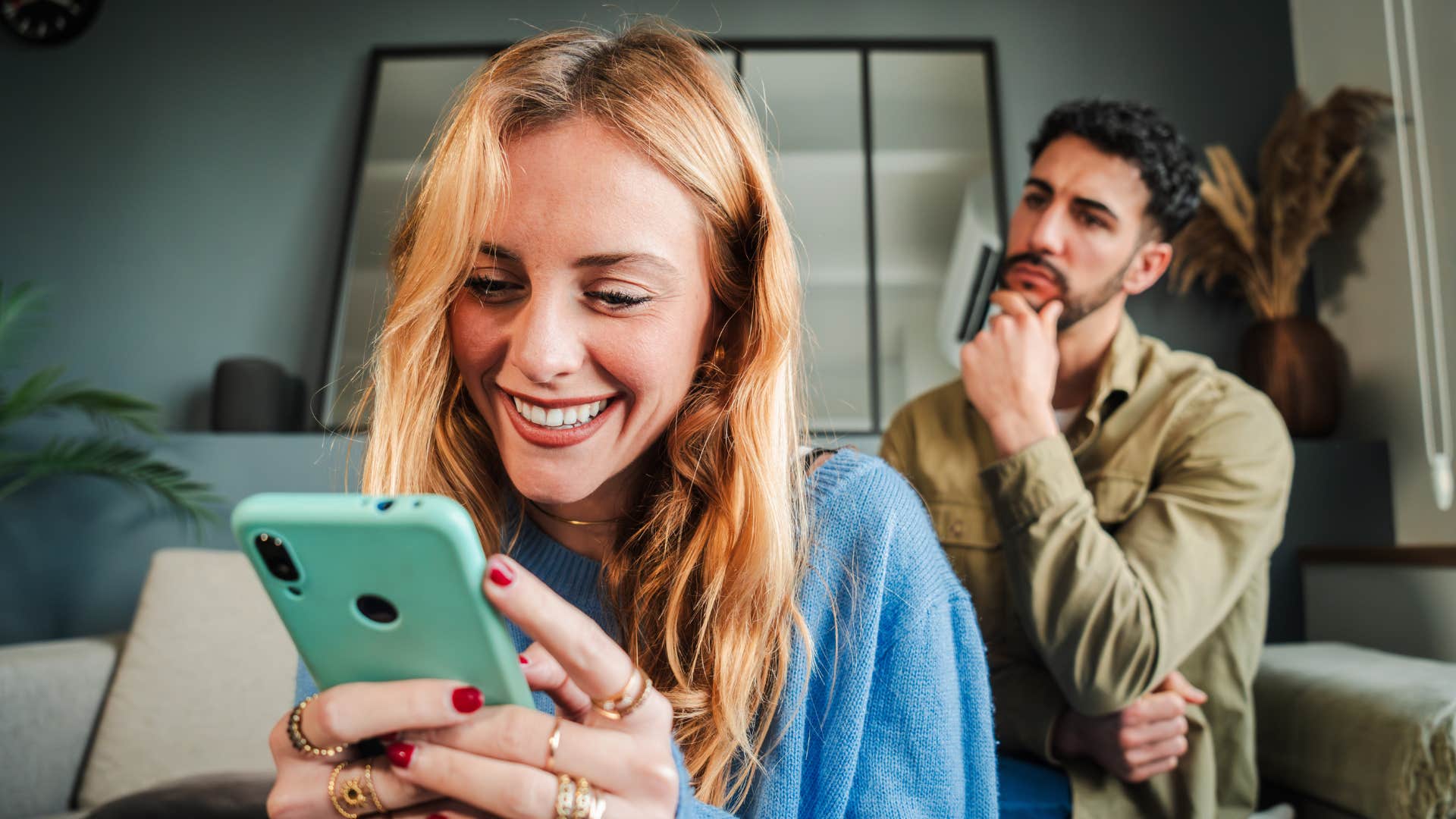 woman driving man away distracted by social media