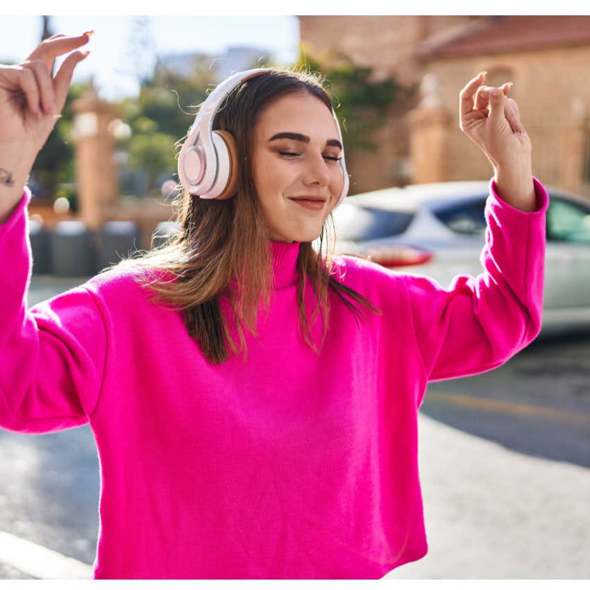 Young woman listening to music and staying in the moment