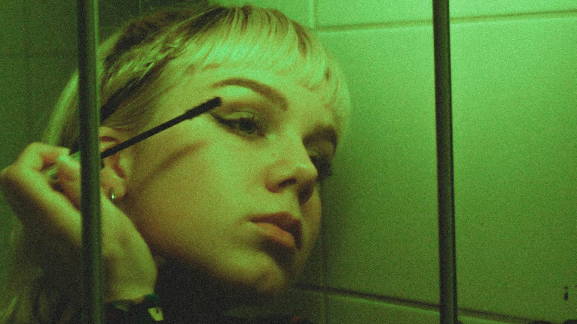 retro photo of girl in bathroom used makeup as a mask instead of a tool
