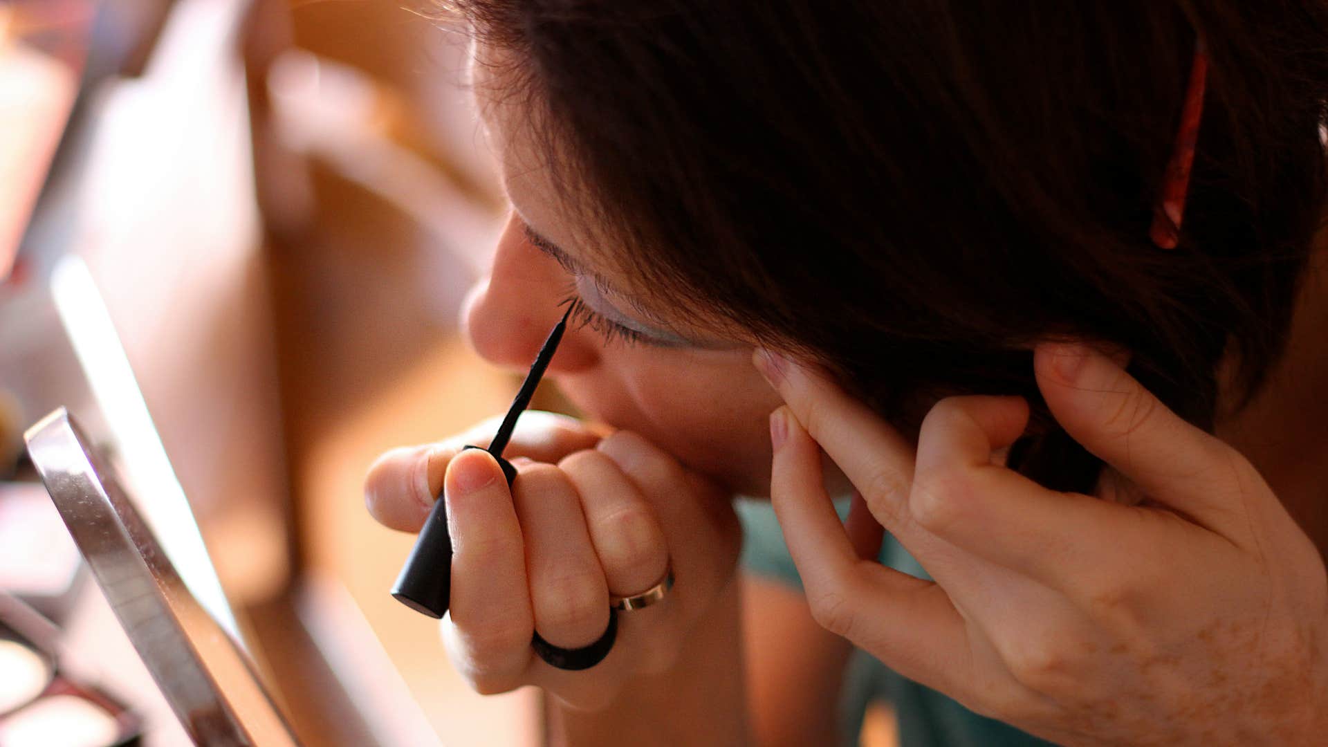 woman pulled and tugged at skin while doing makeup