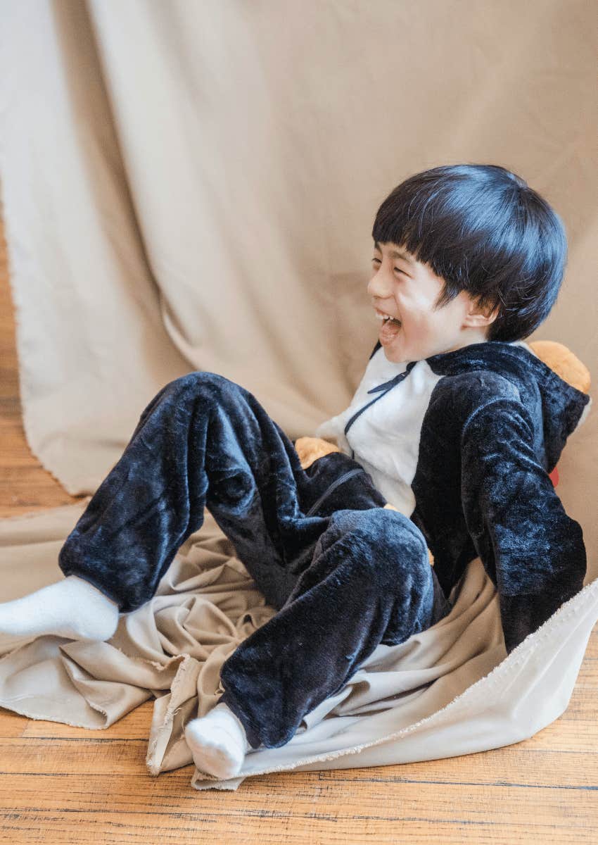 young boy laughing is one of the loudest parts of raising boys