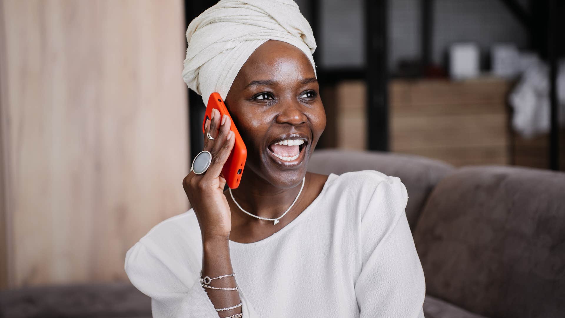 woman getting excited while talking on the phone