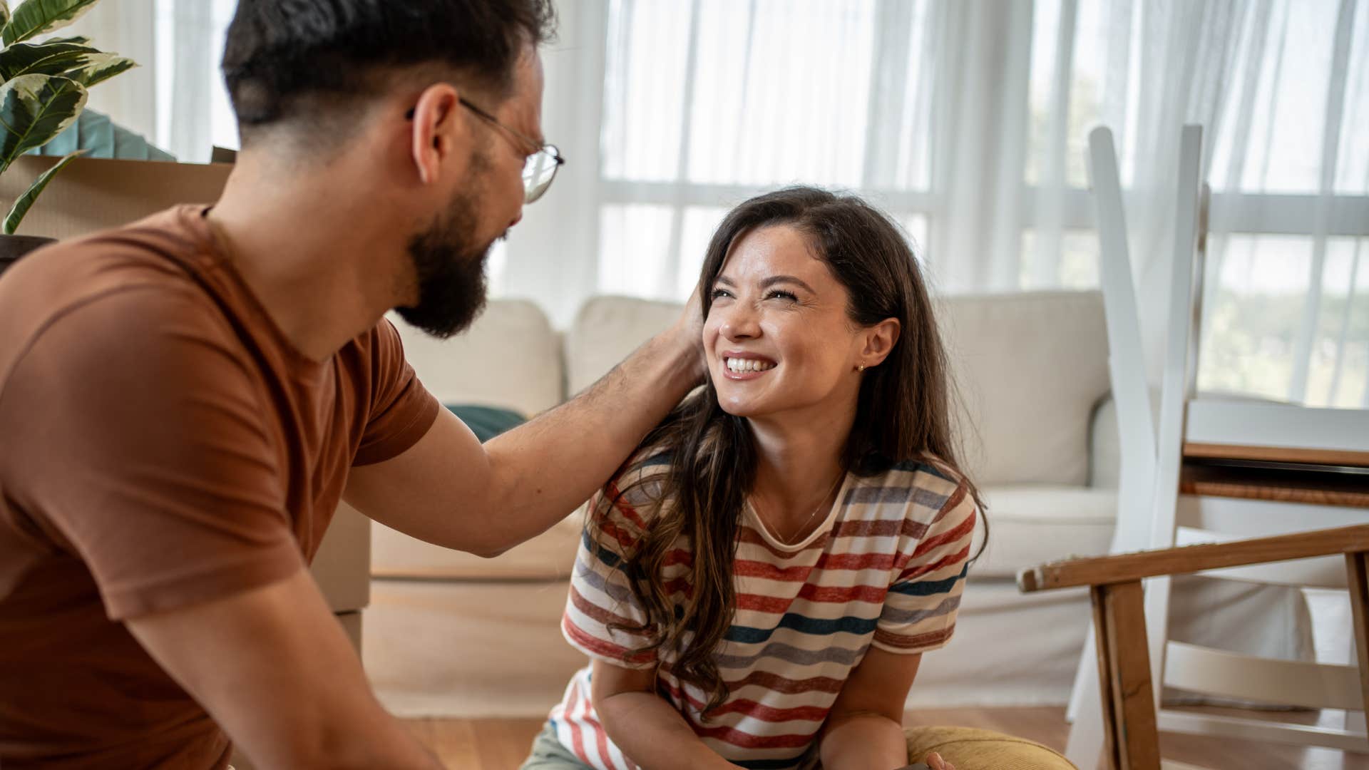 wife smiling as happily married husband celebrates her wins openly