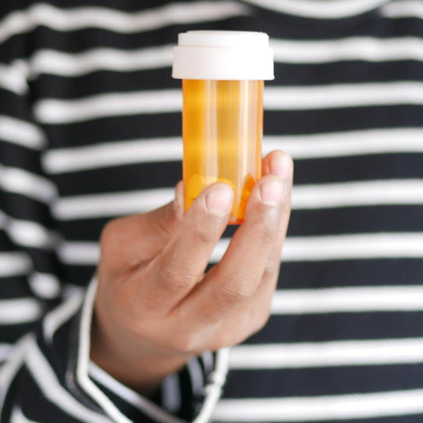 person holding expensive prescription bottle