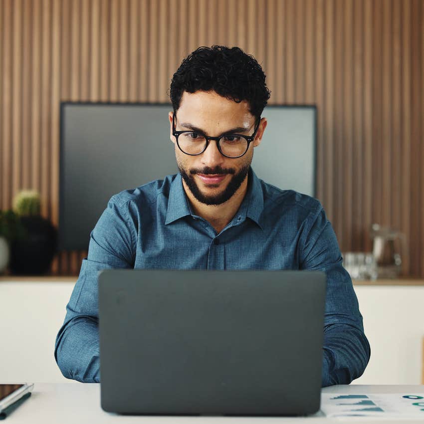 man working on his laptop sitting at desk
