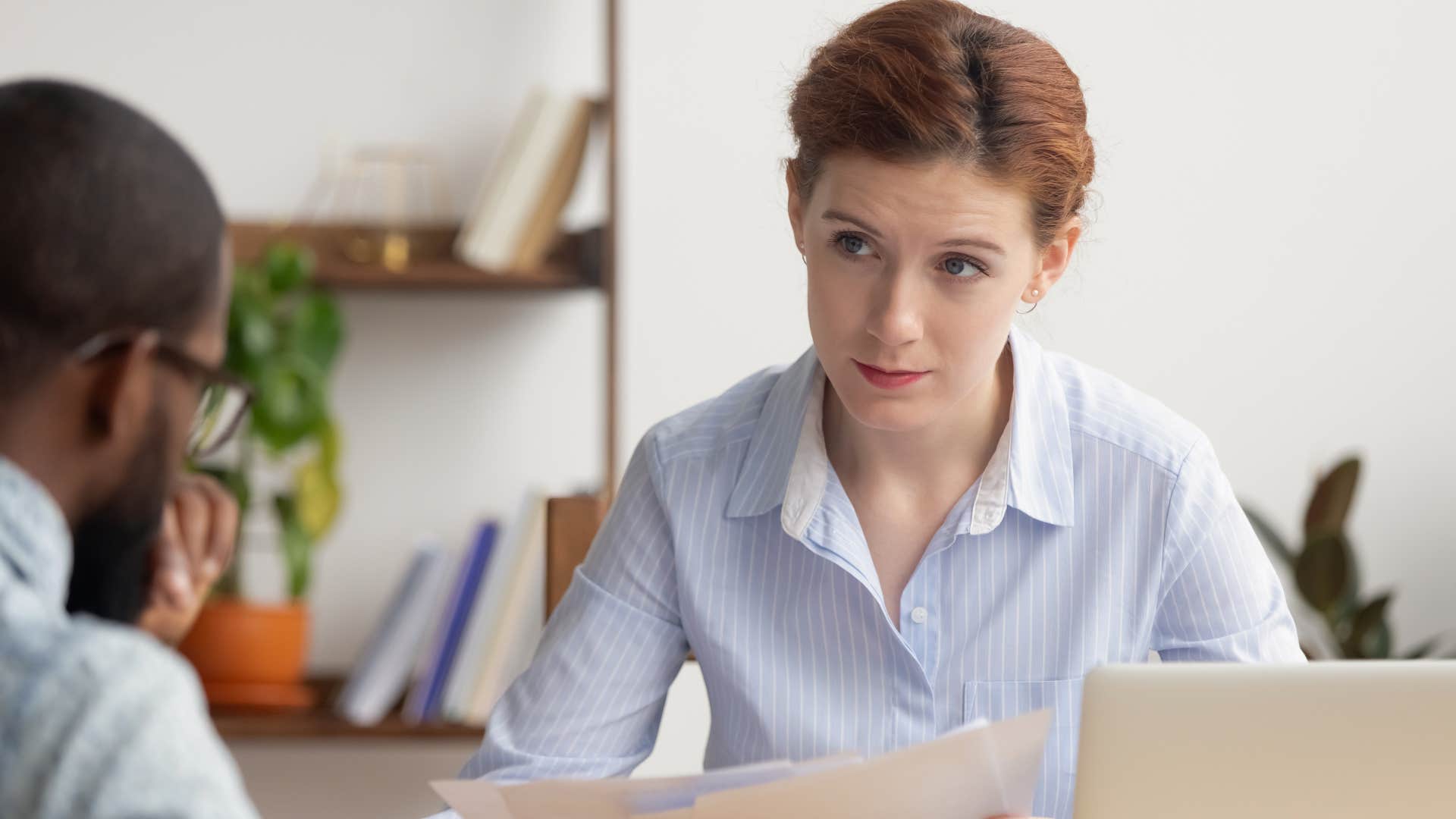 Woman saying "How much did that cost?" to her co-worker.