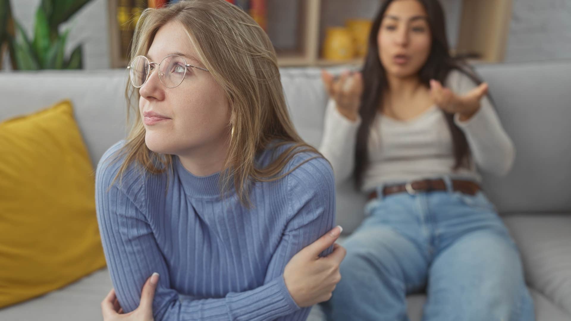 Woman saying "What really happened?" to her friend.