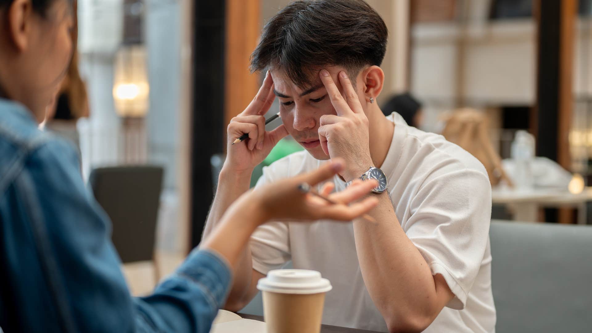 Man asking his upset friend, "Why don't you drink?"